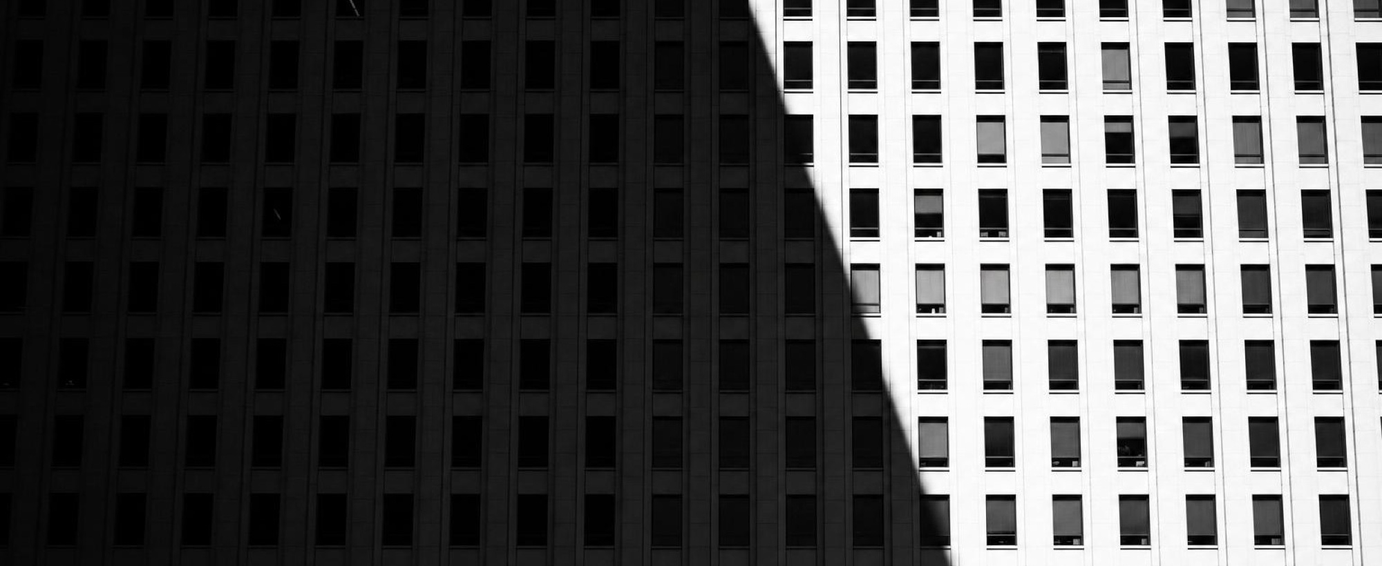 Office towers seen from below, their windows in a tight grid