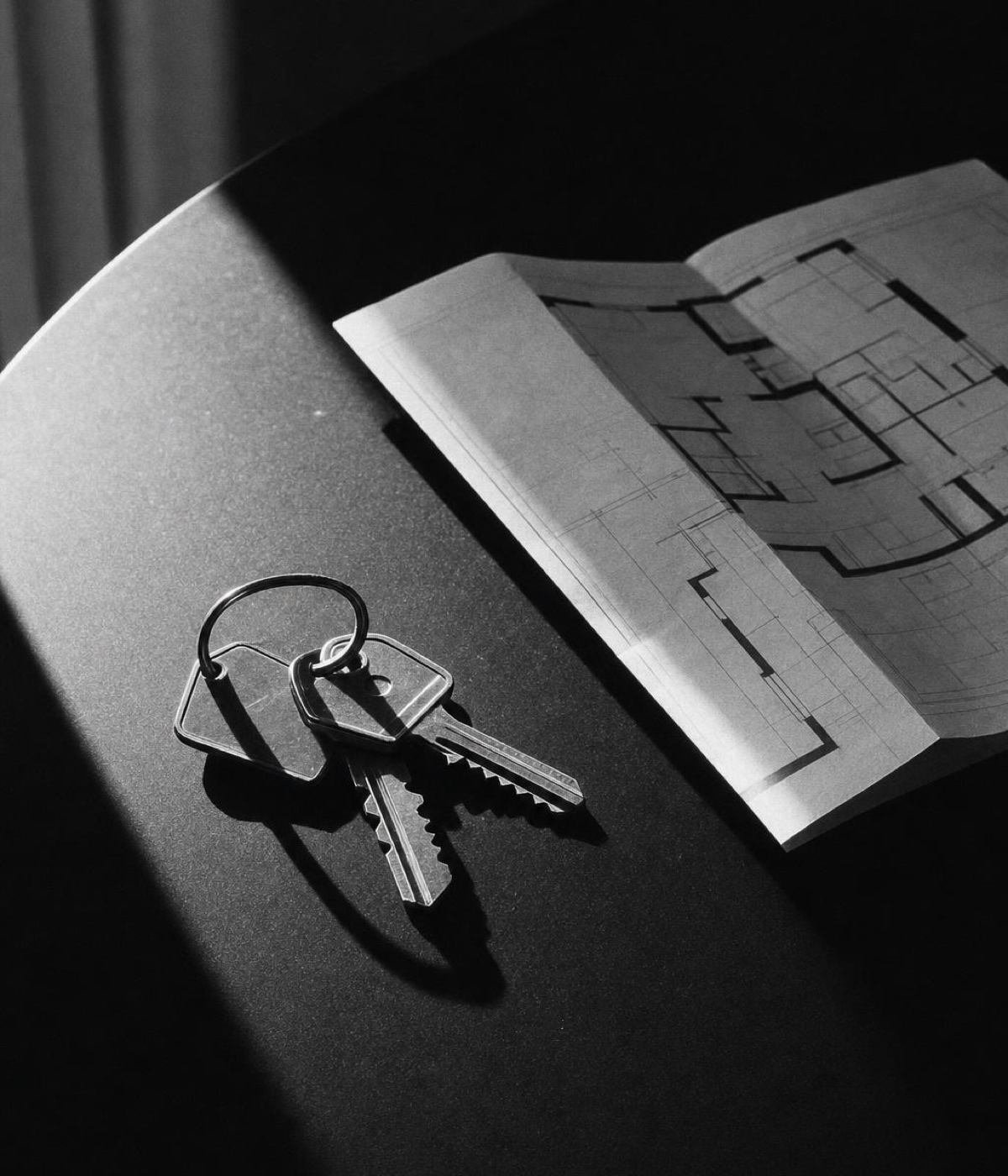 A set of keys beside a printed floor plan